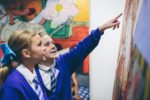 Children look at artwork