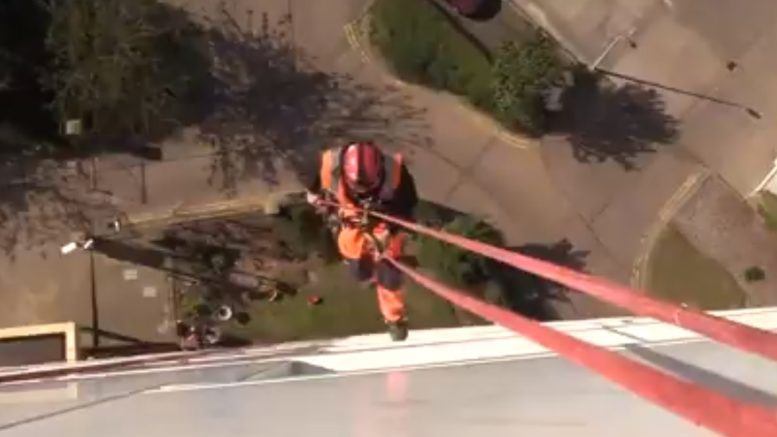 One of the abseilers who cleans cladding on Hull City Council's 26 tower blocks.