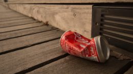 An empty drinks can thrown on the ground.