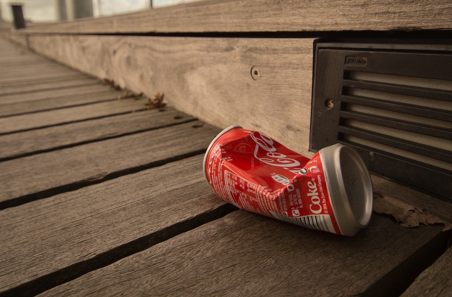An empty drinks can thrown on the ground.