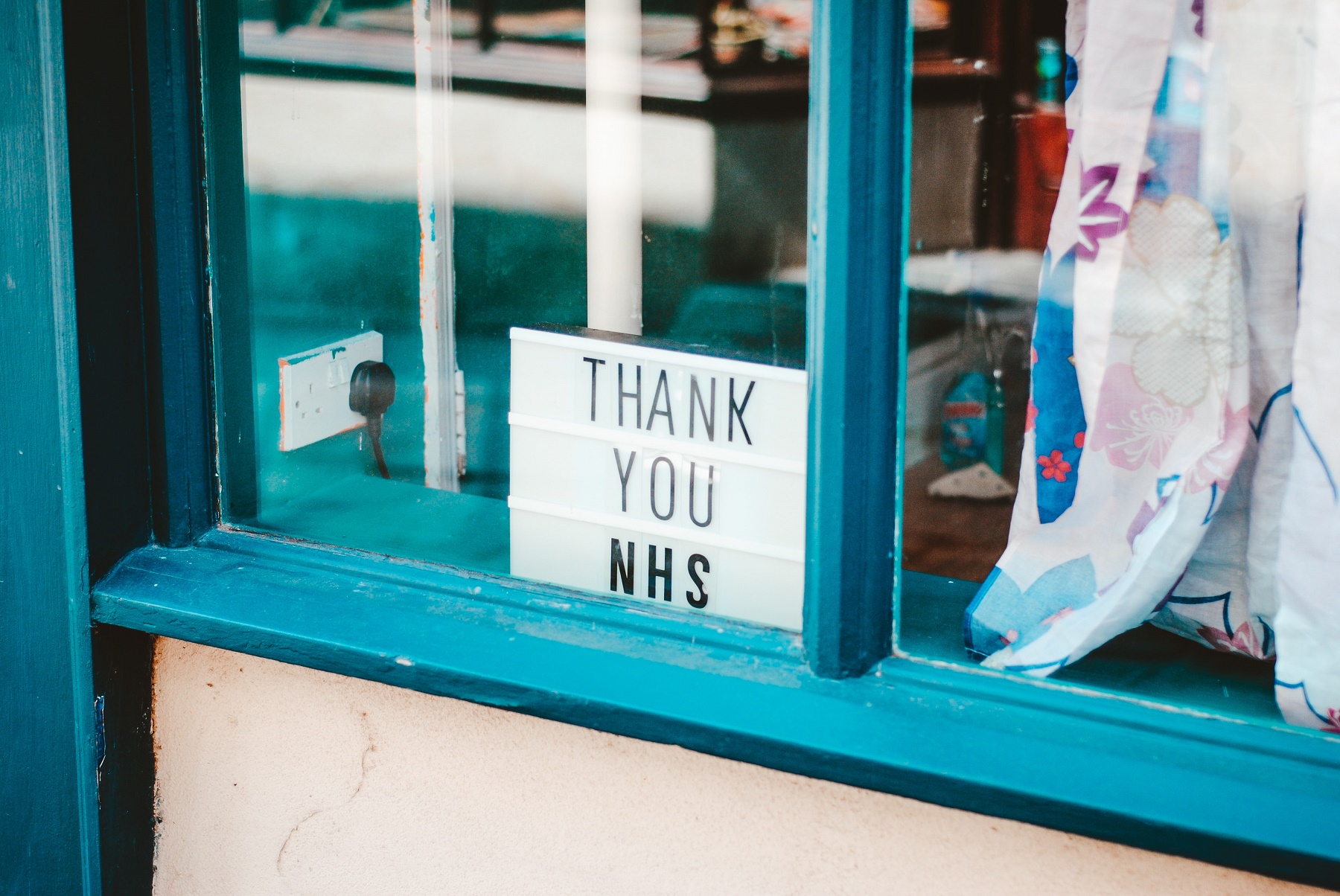 A sign saying 'thank you NHS' in a window