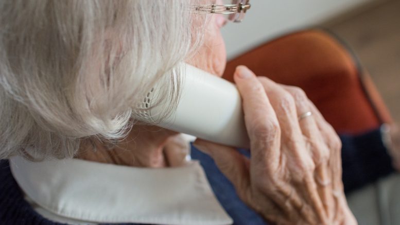 An elderly woman on the phone.