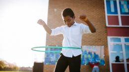 A boy with a hula hoop.