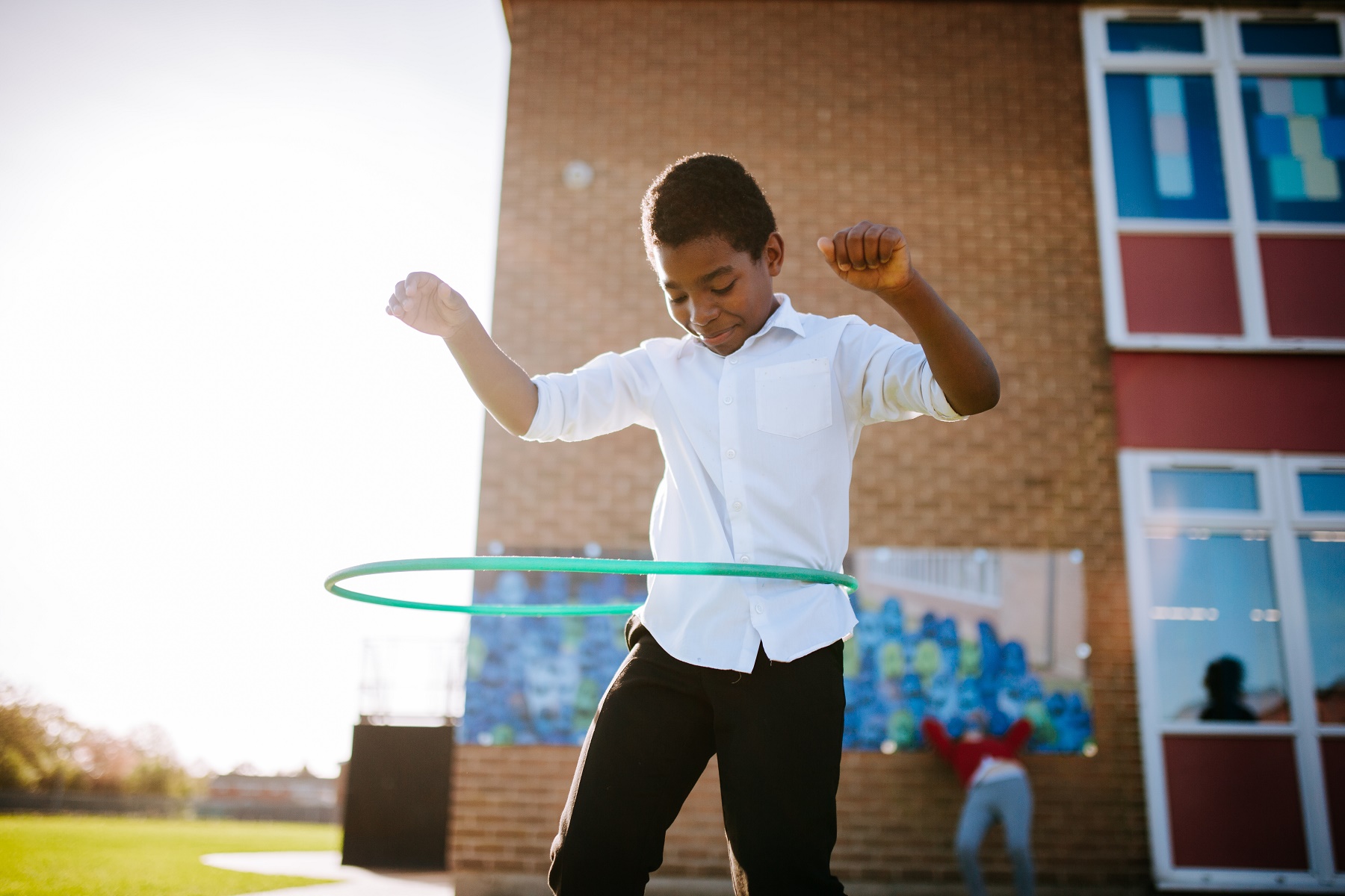 A boy with a hula hoop.