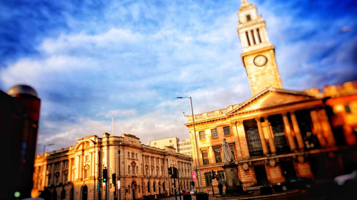 A stylised photo shows Hull's Guildhall, where the council is based, under a wintery blue sky