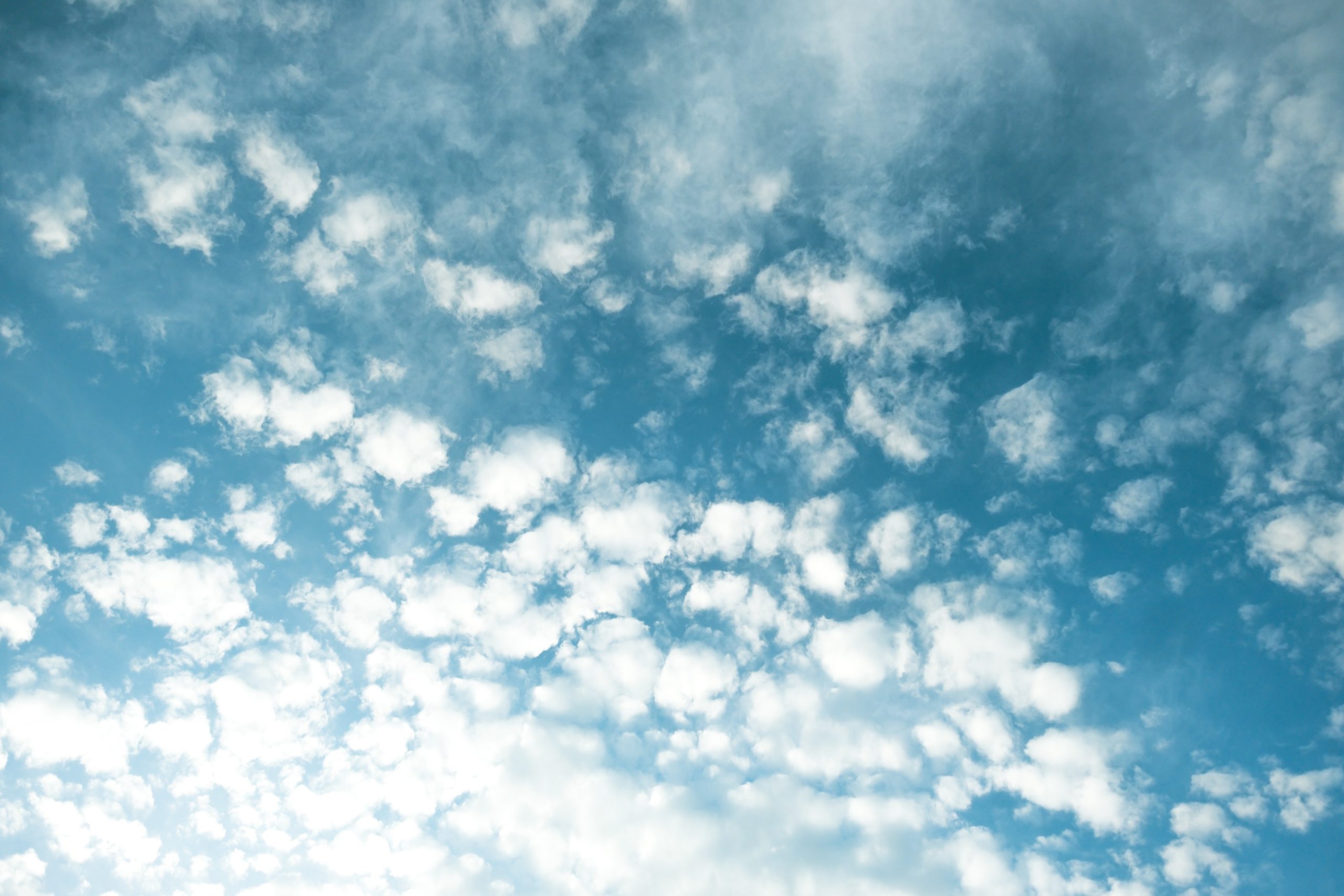 a photo of a blue, summery sky with with fluffy white clouds