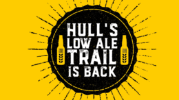 a bright yellow background with a black circle. Inside the circle is white text and an image of two beer bottles. The text reads: Hull's Low Ale Trail is back