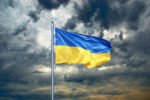 Ukrainian flag on cloudy sky.