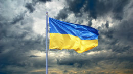 Ukrainian flag on cloudy sky.