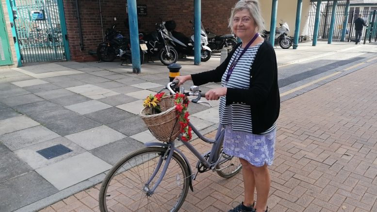 Kate with her bike which she uses to cycle to and from work.