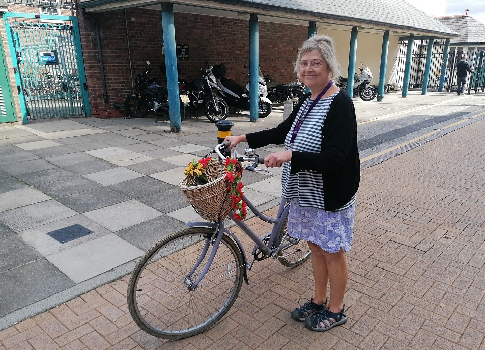 Kate with her bike which she uses to cycle to and from work.