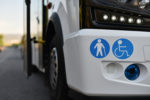 A bus with stickers of places for a disabled person and elderly on body