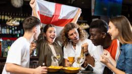 England fans cheering together inside a pub