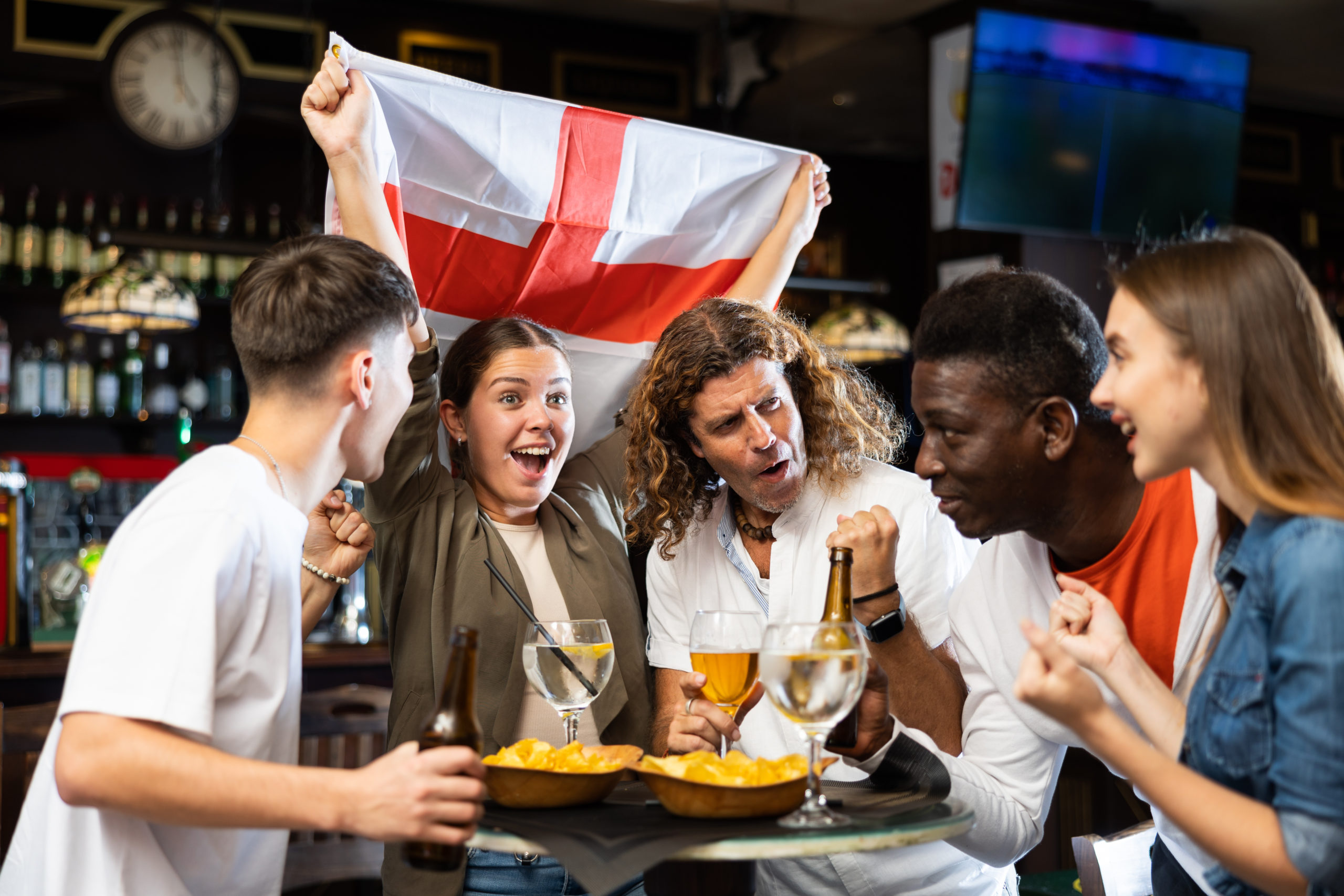 England fans cheering together inside a pub