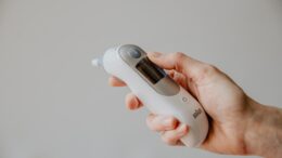 a hand holds a digital thermometer