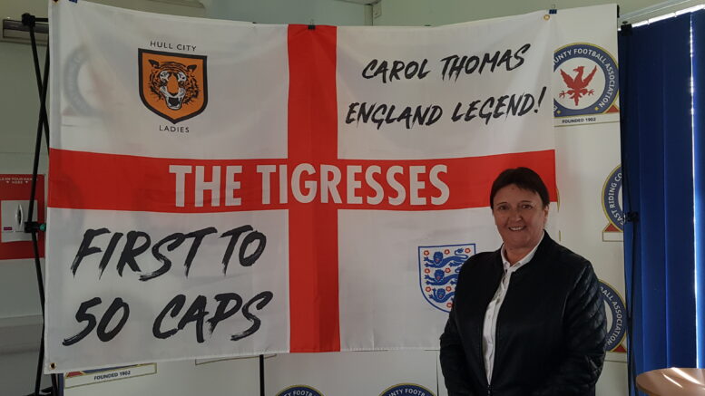 Carol Thomas in front of an England and Hull City flag