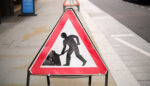 Close-up of a roadworks sign on a pavement