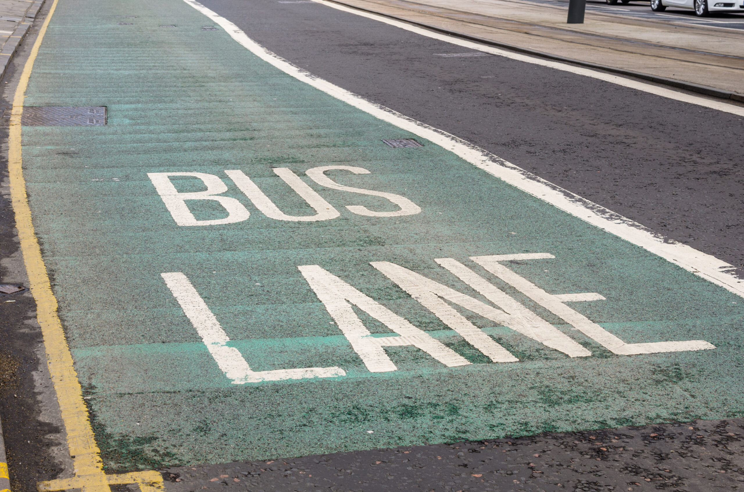 A bus lane with green paint
