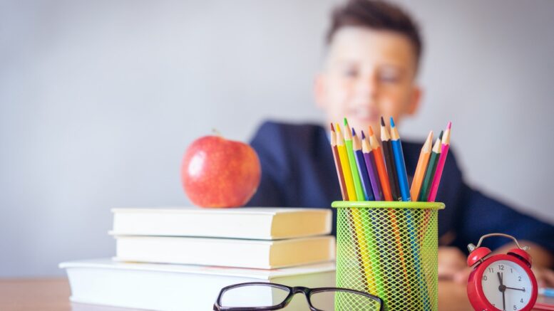 School child with school stationary.