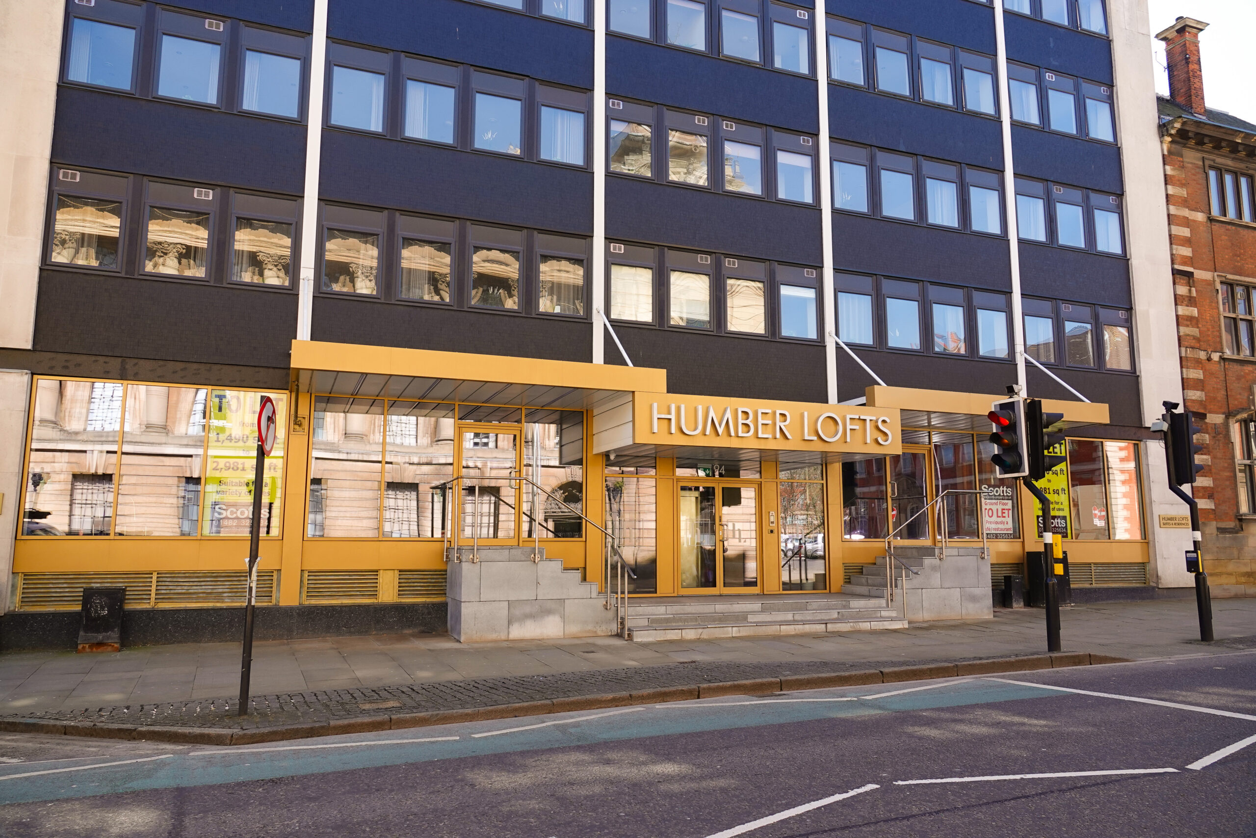 A building clad in gold with Humber Lofts printed above the door