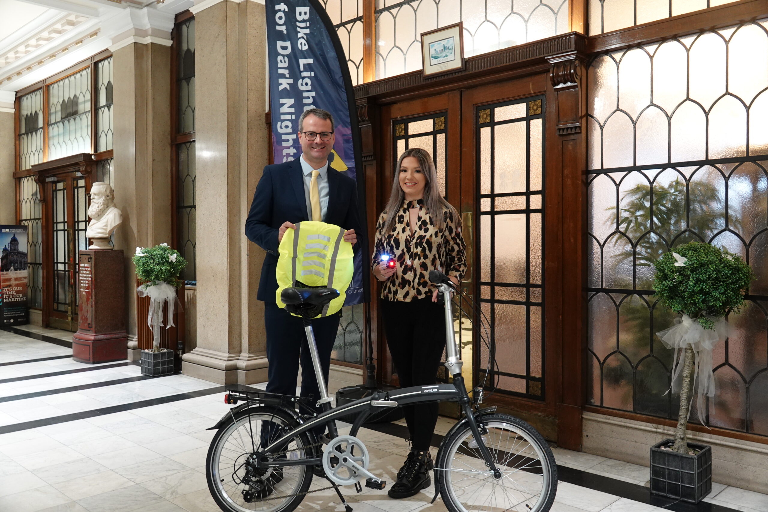 Bike Lights for Dark Nights flag, with Hull City Council staff, a bike and cycle accessories