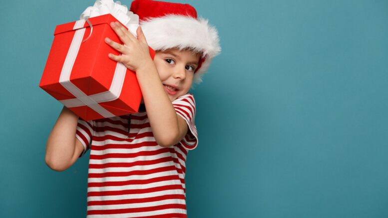 A child holding a Christmas present