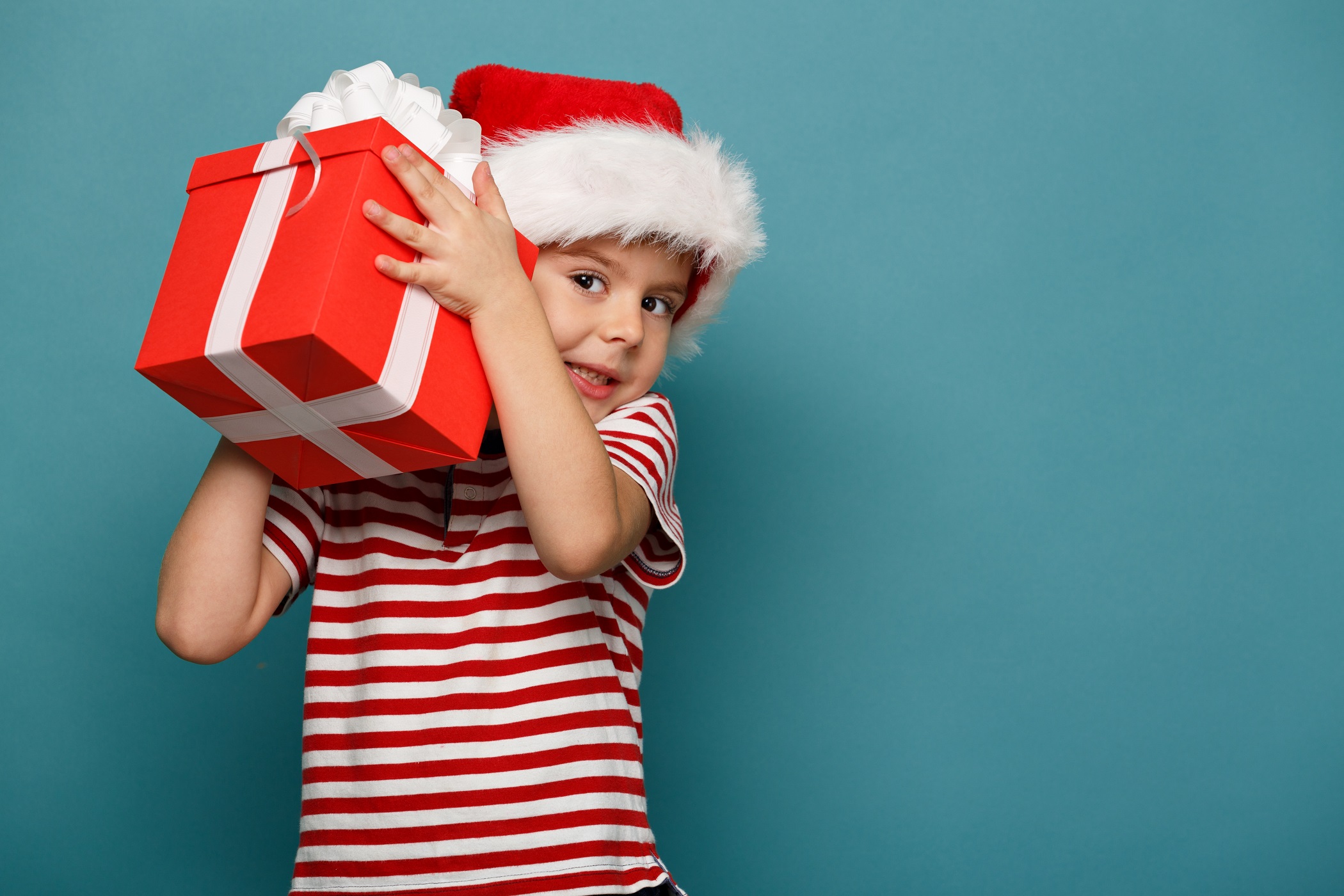 A child holding a Christmas present