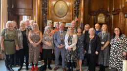 The image is of the Lord Mayor and Councillor Tock alongside the long serving foster carers. Everyone is smiling.