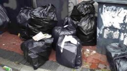 Waste fly-tipped by Samuel Litchfield of Stanley Street, Hull. Imager shows several black bags full of waste on the ground next to three black bins.