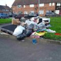 Waste fly-tipped by Declan Hooley of Dodswell Grove. Shows rubbish piled up on grass verge.