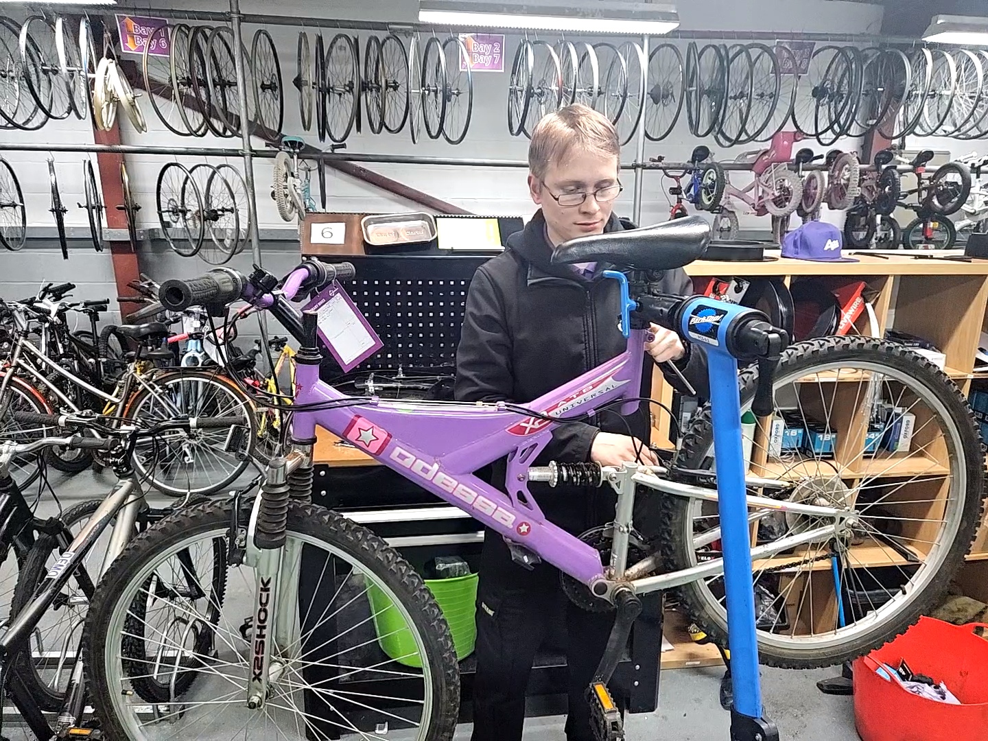 Jason Wigmore, cycle mechanic, working on a bike