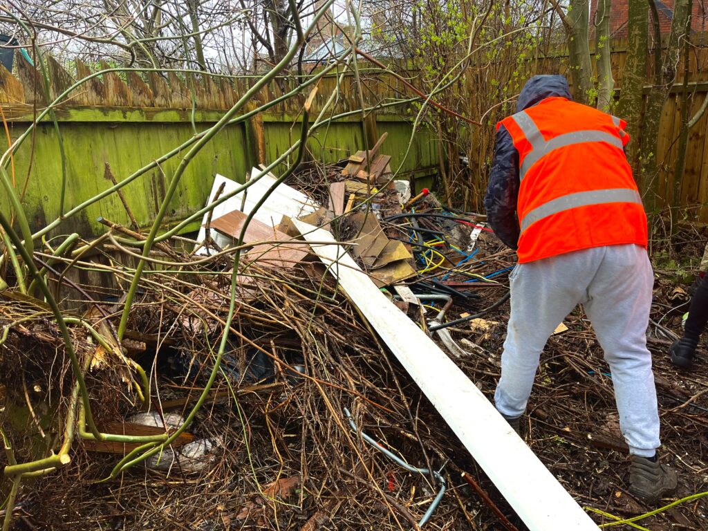 A member of the Rapid Deployment team tackling fly-tipping at a property on Doncaster Street, Hull.