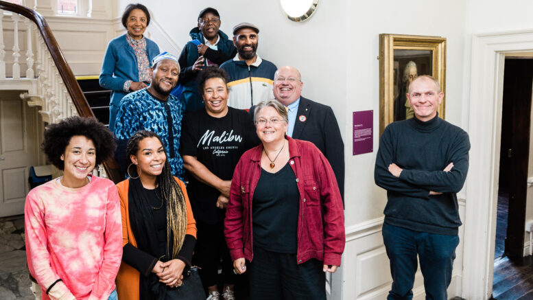 A group of 10 people stand on the staircase of Wilberforce House