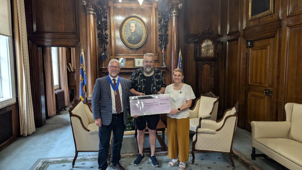 2023-24 Lord Mayor Cllr Kalvin Neal and past Lady Mayoress Cllr Tracey Neal hand over a cheque to Andy Train from Hull LGBT+ Community Pride