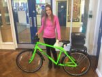 A student from Stockwell Primary School is presented with a Frog bike.