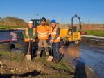 Hull Adventure Centre manager John Haines, High-Low Ropes Course Consulting Ltd CEO Ali Glendinning and Hull City Council's portfolio holder for regeneration and housing Cllr Paul Drake-Davis in hard hats and hi-viz with shovels.