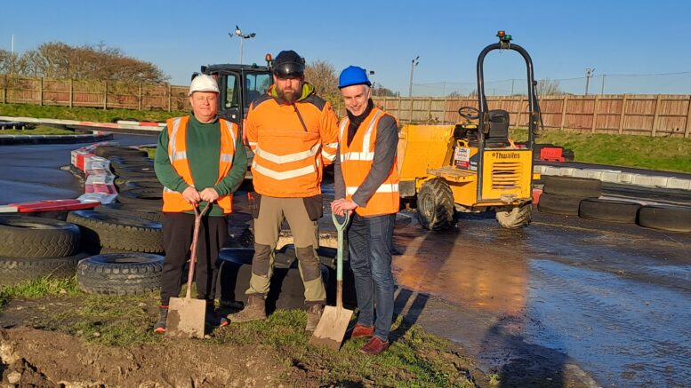 Hull Adventure Centre manager John Haines, High-Low Ropes Course Consulting Ltd CEO Ali Glendinning and Hull City Council's portfolio holder for regeneration and housing Cllr Paul Drake-Davis in hard hats and hi-viz with shovels.