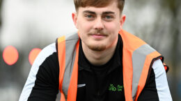 First Step Sports Coach, Jacob Dennis, sat on a bike