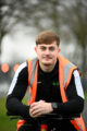 First Step Sports Coach, Jacob Dennis, sat on a bike