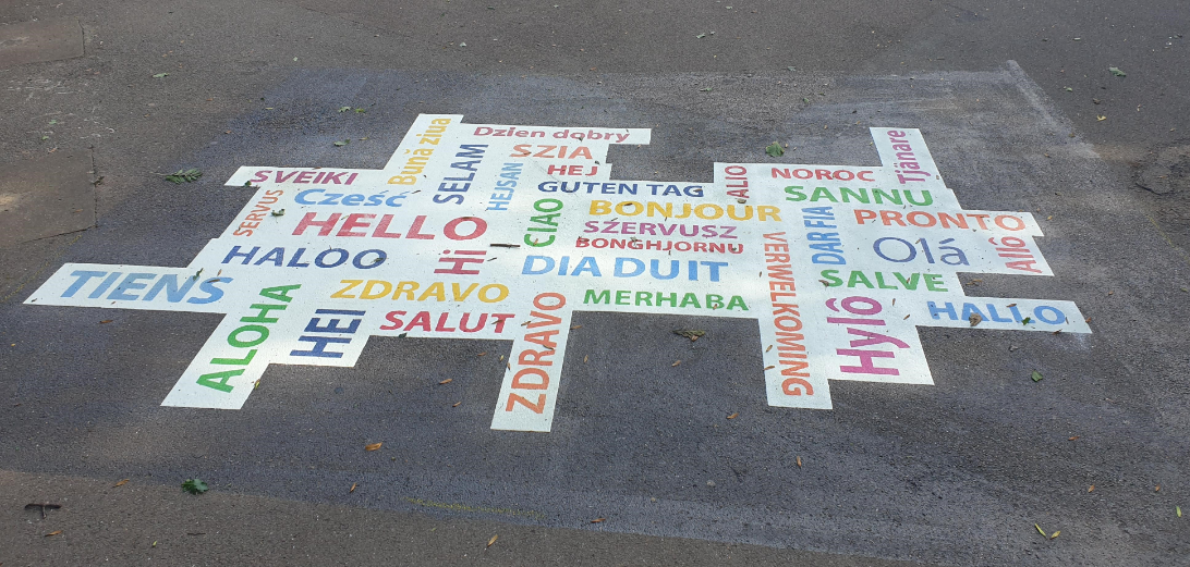 A Hello graphic featuring multiple languages which will be on the ground at Bean Street Play Area
