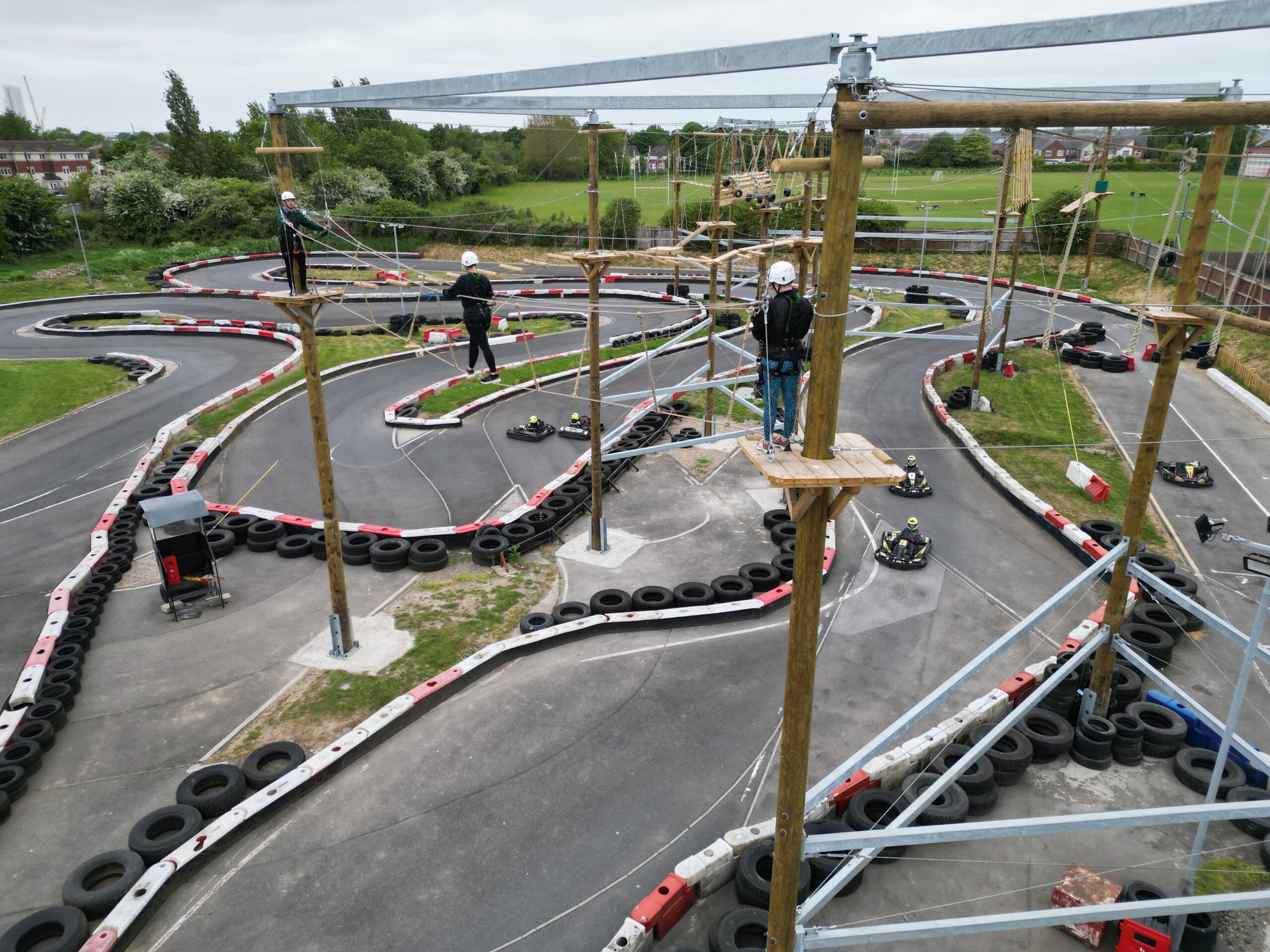 Karts race below those tackling the new high ropes course.