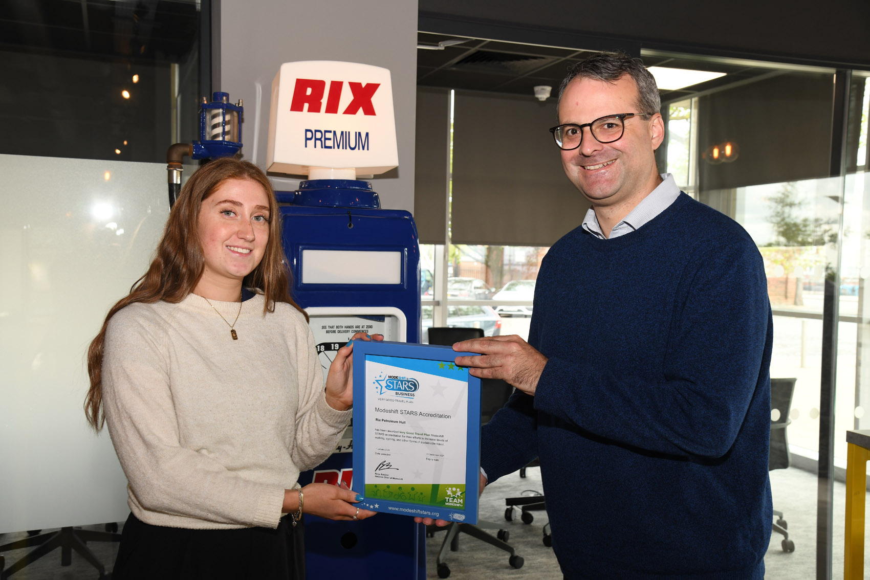 Councillor Mark Ieronimo, cabinet portfolio holder for transportation, roads and highways from Hull City Council, presents the Rix Group’s certificate to Cerys Davies, business analyst