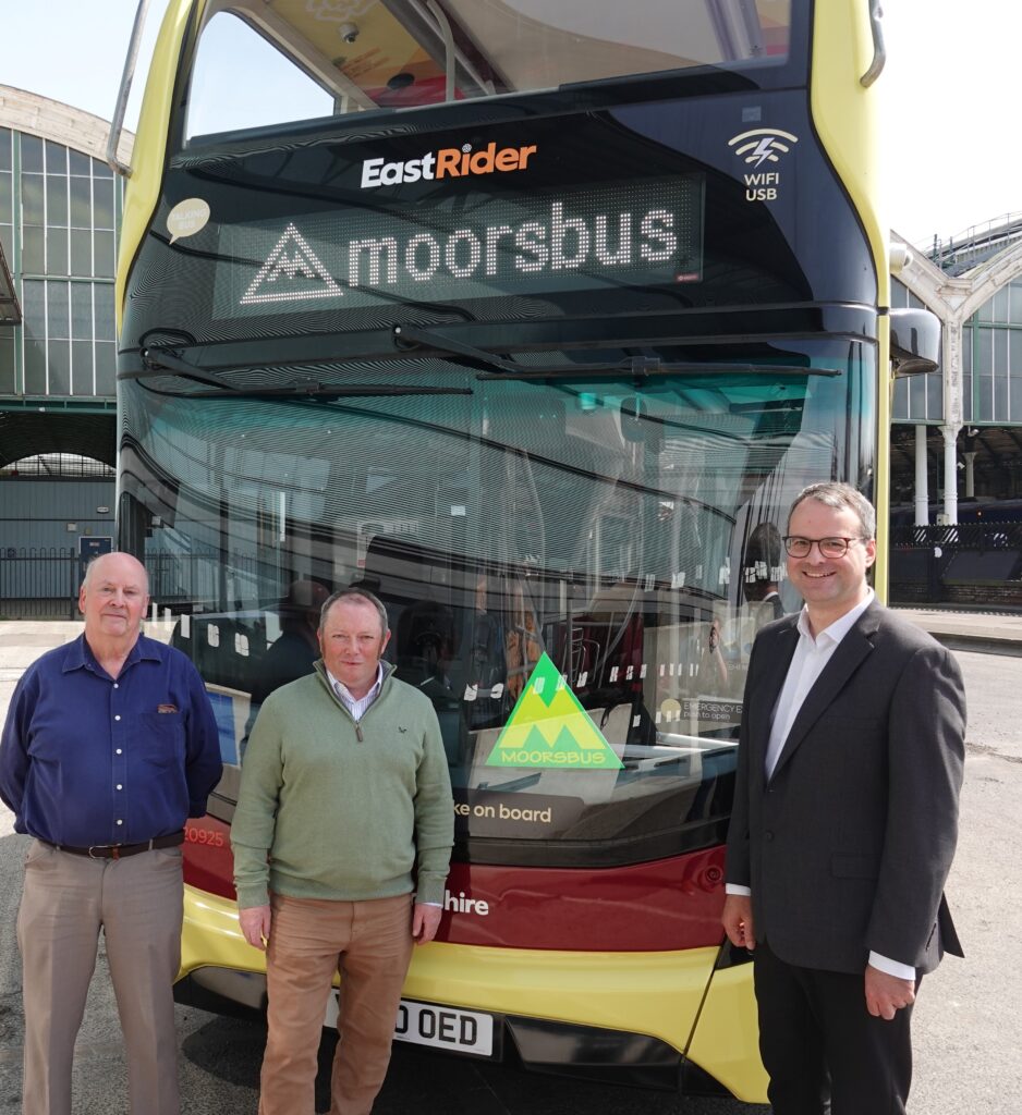 Eden Blyth, Councillor Paul West and Councillor Mark Ieronimo with the Moorsbus (M1) service at Hull Paragon Interchange