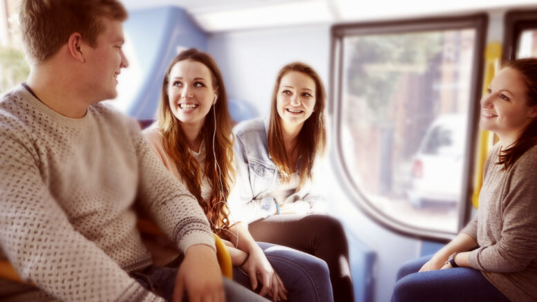 A group of young people on a bus journey together