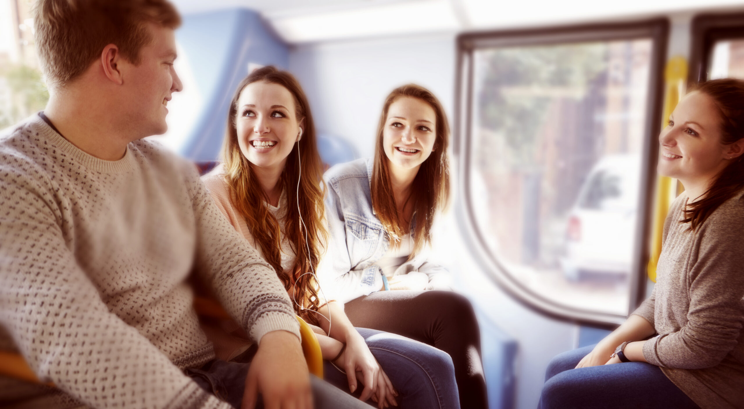 A group of young people on a bus journey together