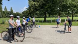 A group of people taking part in an adult cycle training session