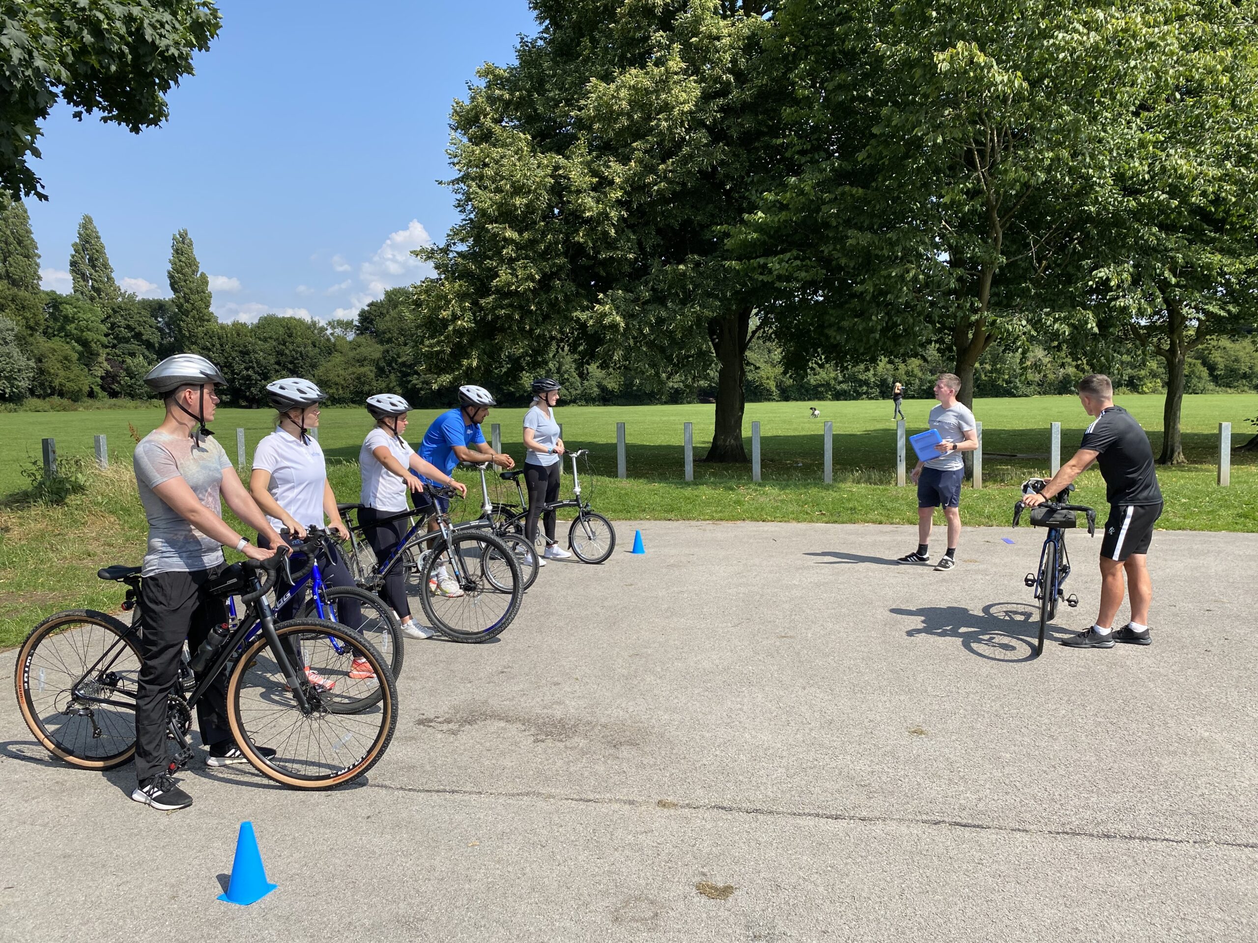 A group of people taking part in an adult cycle training session