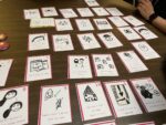 The cards are laid out on a table. They have different captions and images on them.