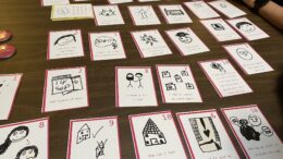 The cards are laid out on a table. They have different captions and images on them.