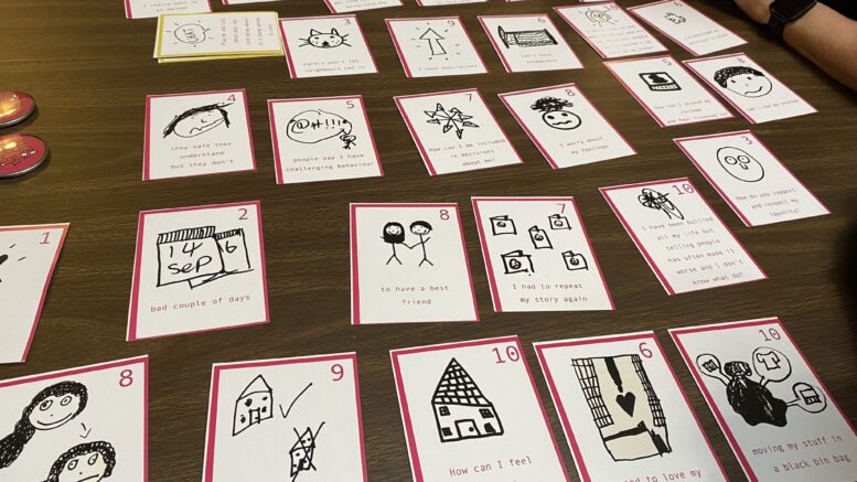 The cards are laid out on a table. They have different captions and images on them.